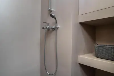 a shower in the corner of a bathroom at Absolute Athens v in Athens