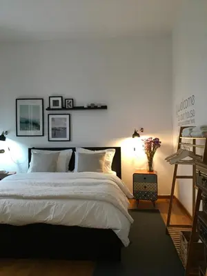 a bedroom with a large white bed with two lamps at Evelina’s apartment in Athens