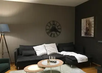 a living room with a couch and a table with candles at Evelina’s apartment in Athens
