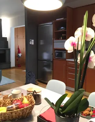 a kitchen with a table with a bowl of fruit at Evelina’s apartment in Athens