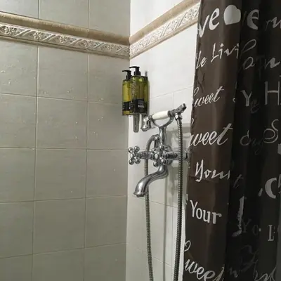 a shower in a bathroom with a shower head at Evelina’s apartment in Athens
