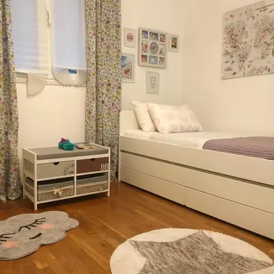 a small bedroom with a bed and a table at Evelina’s apartment in Athens