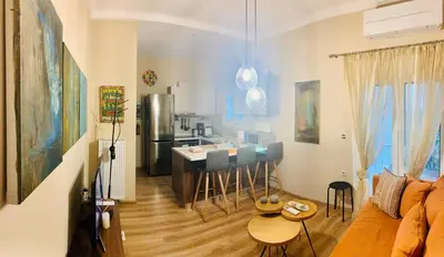 a living room with a kitchen with a counter and a kitchen at Bring only your toothbrush! in Athens