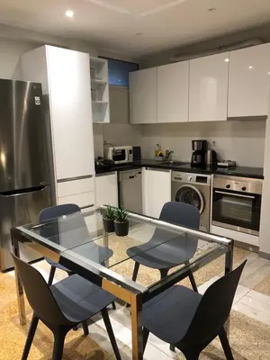 a kitchen with a glass table and chairs at Kleopatra Apartment in Acropolis in Athens