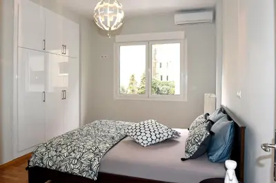 a bedroom with a bed and a window at Kleopatra Apartment in Acropolis in Athens