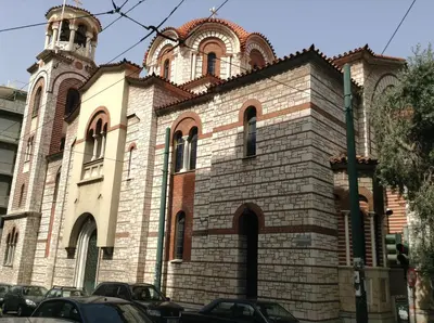 a large brick building with a clock tower at Kleopatra Apartment in Acropolis in Athens