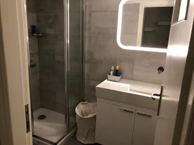 a bathroom with a shower and a sink and a mirror at Kleopatra Apartment in Acropolis in Athens