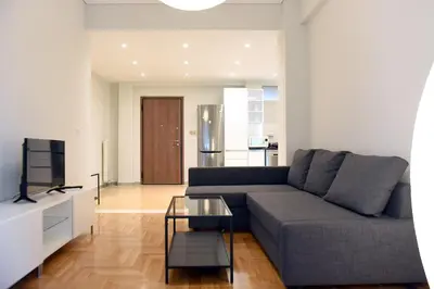 a living room with a couch and a table at Kleopatra Apartment in Acropolis in Athens