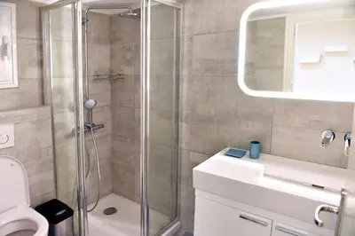 a bathroom with a shower and a toilet and a sink at Kleopatra Apartment in Acropolis in Athens