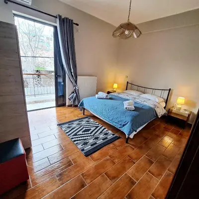 a bedroom with a bed and a large window at Horizon apartment Athens near to Acropolis, sea & subway in Athens