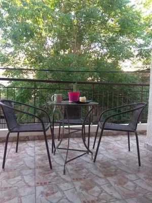 a table and two chairs on a patio at Horizon apartment Athens near to Acropolis, sea & subway in Athens