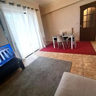 a living room with a table and chairs and a door at Horizon apartment Athens near to Acropolis, sea & subway in Athens