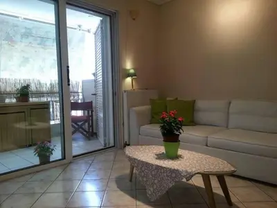 a living room with a couch and a table at Lovely apartment near Akropolis and Plaka in Athens