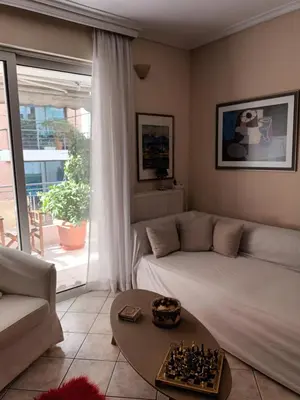 a living room with a bed and chess board on a table at Lovely apartment near Akropolis and Plaka in Athens