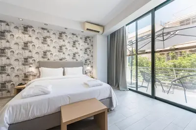 a bedroom with a bed and a large window at Athens Lights in Athens