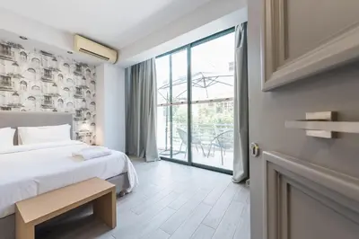 a bedroom with a bed and a large window at Athens Lights in Athens