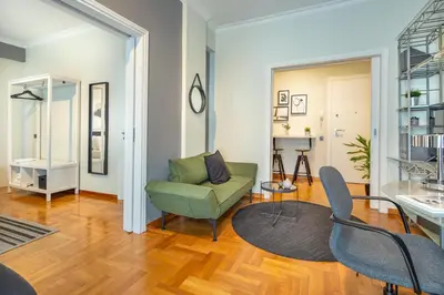 a living room with a green couch and chairs at Superb 1BD Apartment in the heart of Kolonaki by UPSTREET in Athens