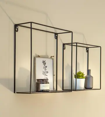 a shelf with a vase a clock and a vase at Superb 1BD Apartment in the heart of Kolonaki by UPSTREET in Athens