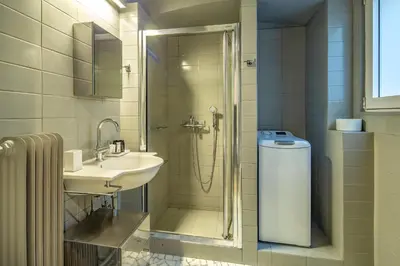 a bathroom with a shower and a sink and a shower at Superb 1BD Apartment in the heart of Kolonaki by UPSTREET in Athens