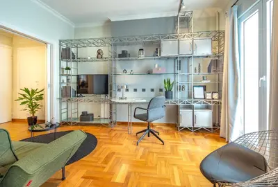a living room with a couch and a chair and a desk at Superb 1BD Apartment in the heart of Kolonaki by UPSTREET in Athens