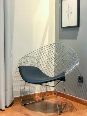 a mesh chair sitting in a room at Superb 1BD Apartment in the heart of Kolonaki by UPSTREET in Athens