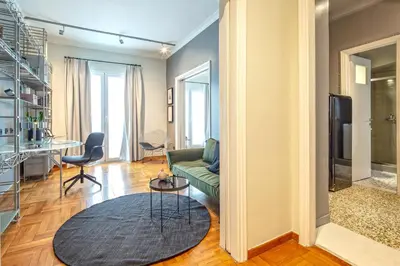 a living room with a couch and a table at Superb 1BD Apartment in the heart of Kolonaki by UPSTREET in Athens