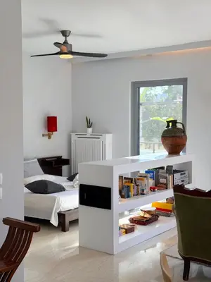 a bedroom with a bed and a book shelf with books at Friends & Family in Athens
