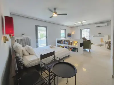 a bedroom with a bed and a table and chairs at Friends & Family in Athens