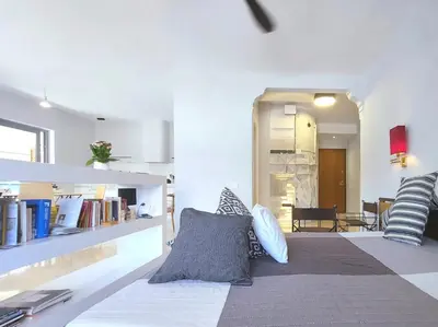a living room with a bed with pillows on it at Friends & Family in Athens