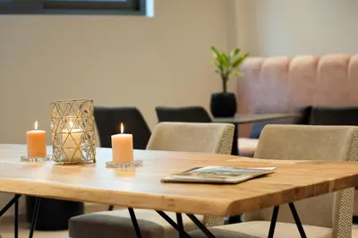 a wooden table with two candles on top of it at Athens Platinum Rooms and Suites in Athens