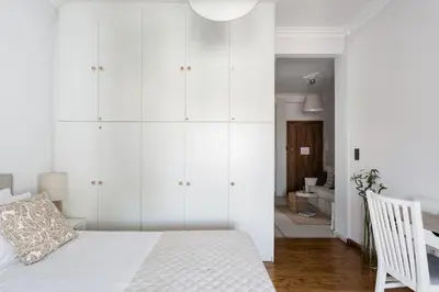 a bedroom with white cabinets and a bed at Romantic Love-Nest Studio Near Acropolis & Metro in Athens