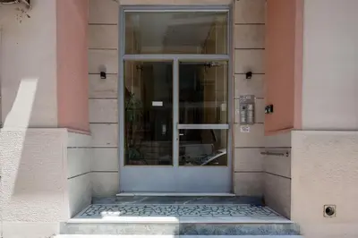 a glass door on a building with at Romantic Love-Nest Studio Near Acropolis & Metro in Athens