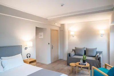 a hotel room with a bed and a couch at Chroma Fashion Rooms & Apartments in Athens