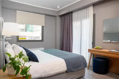 a bedroom with a bed and a desk at Chroma Fashion Rooms & Apartments in Athens