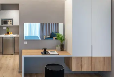 a kitchen with a desk with a mirror at Chroma Fashion Rooms & Apartments in Athens
