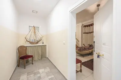 a hallway leading to a living room with white walls at Athenian Niche in Plaka Villa by Athenian Homes in Athens