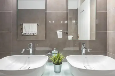 a bathroom with two sinks and a tub at Athenian Niche in Plaka Villa by Athenian Homes in Athens