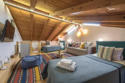 a large room with a bed and a couch at Athenian Niche in Plaka Villa by Athenian Homes in Athens