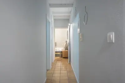 a hallway with a white wall and a room at Athenian Niche in Plaka Villa by Athenian Homes in Athens