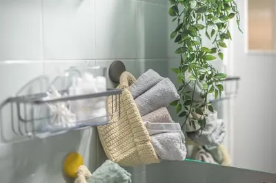 a rack with towels and a plant in a bathroom at Sweet home in Koukaki in Athens