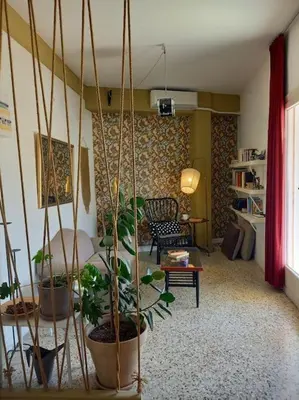a living room filled with lots of potted plants at Miaouli8 in Athens