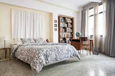 a bedroom with a bed and a book shelf at Miaouli8 in Athens