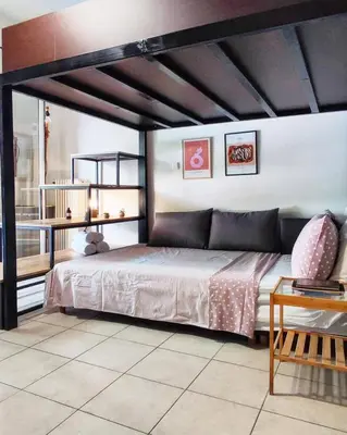 a bedroom with a large bed and a table at As Acropolis studio Apartment in Athens
