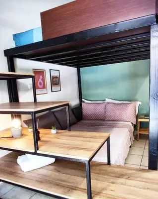 a bedroom with a bunk bed with a wooden table at As Acropolis studio Apartment in Athens