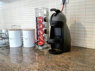 a coffee maker and cups on a kitchen counter at As Acropolis studio Apartment in Athens