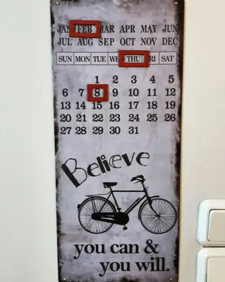 a calendar hanging on a wall with a bike at As Acropolis studio Apartment in Athens