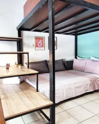 a bed and a table in a room with a bed and a desk at As Acropolis studio Apartment in Athens