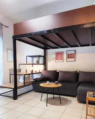a living room with a couch and a table at As Acropolis studio Apartment in Athens