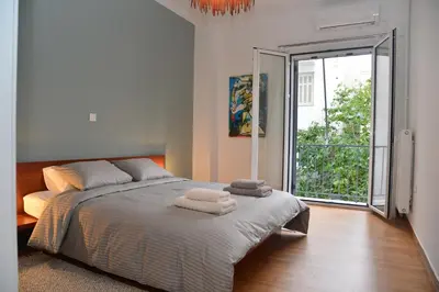 a bedroom with a large bed with towels on it at Athens Destination: a home away from home in Athens