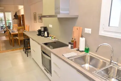 a kitchen with a sink and a counter top at Athens Destination: a home away from home in Athens